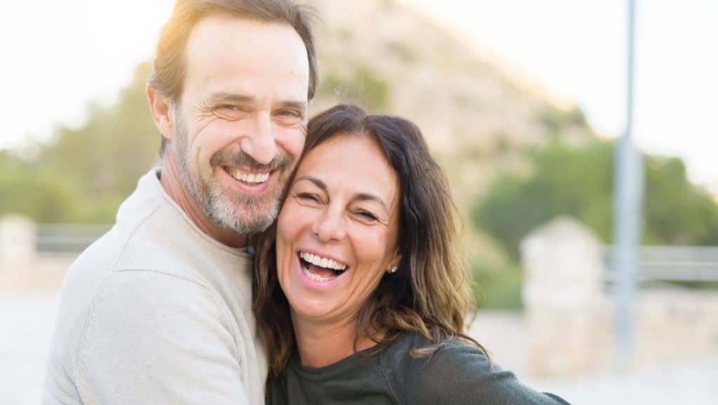 couple smiling and cuddling 